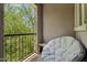 Relaxing balcony with a comfortable chair and a view of the surrounding trees at 2313 E Hidalgo Ave, Phoenix, AZ 85040
