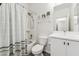 Well-lit bathroom with a shower-tub combo and a vanity with storage space at 2313 E Hidalgo Ave, Phoenix, AZ 85040