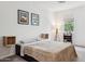 Inviting bedroom with natural light, stylish wall art, and a comfortable, cozy bed at 2313 E Hidalgo Ave, Phoenix, AZ 85040