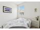 Cozy bedroom featuring a bright window view, neutral tones, and minimalist decor at 2313 E Hidalgo Ave, Phoenix, AZ 85040