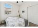 Bright bedroom with large window, neutral walls, and slider door closet at 2313 E Hidalgo Ave, Phoenix, AZ 85040