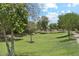 Community green space with mature trees, lush green grass, and a shaded gazebo at 2313 E Hidalgo Ave, Phoenix, AZ 85040
