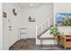 Inviting entryway with modern decor, stylish wood floors, and a staircase leading to upper levels at 2313 E Hidalgo Ave, Phoenix, AZ 85040