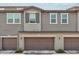 Charming multi-level townhome featuring an attached two-car garage and neutral-toned exterior at 2313 E Hidalgo Ave, Phoenix, AZ 85040