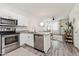 Open kitchen with stainless steel appliances that flows into the comfortable living area at 2313 E Hidalgo Ave, Phoenix, AZ 85040