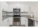 Modern kitchen with stainless steel appliances, granite countertops, and white subway tile backsplash at 2313 E Hidalgo Ave, Phoenix, AZ 85040