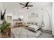 Bright living room open to the kitchen, featuring modern decor, a ceiling fan, and wood-style floors at 2313 E Hidalgo Ave, Phoenix, AZ 85040