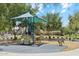 Community playground with a shade structure, slide, and spring riders for  at 2313 E Hidalgo Ave, Phoenix, AZ 85040