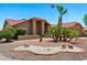 Beautiful desert landscaping with palm trees and a circular rock garden adds to the curb appeal of this home at 2488 Leisure World --, Mesa, AZ 85206