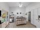 Eat-in kitchen includes a prep island, tile floors and white cabinetry at 2488 Leisure World --, Mesa, AZ 85206