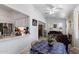 Bright living room with a view into the kitchen with granite countertops and a stone fireplace at 2488 Leisure World --, Mesa, AZ 85206
