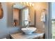 Well-lit bathroom boasts a stylish vessel sink, sleek vanity, and a modern design at 2524 S El Paradiso -- # 17, Mesa, AZ 85202