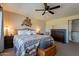 Comfortable primary bedroom featuring a ceiling fan, dresser, and stylish bedside tables for a restful ambiance at 2524 S El Paradiso -- # 17, Mesa, AZ 85202