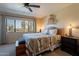Comfortable bedroom featuring a ceiling fan, a large window with views, and stylish bedside tables for a peaceful retreat at 2524 S El Paradiso -- # 17, Mesa, AZ 85202