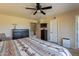 Spacious bedroom with carpet flooring, ceiling fan, a dresser, and a view of the stairs from the bed at 2524 S El Paradiso -- # 17, Mesa, AZ 85202