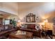 Inviting living room with plush brown leather sofas, wooden coffee table, and stylish decor, creating a cozy atmosphere at 2524 S El Paradiso -- # 17, Mesa, AZ 85202
