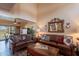 Relaxing living room with brown leather sofas, wooden coffee table, and view to the outdoors from the sliding glass doors at 2524 S El Paradiso -- # 17, Mesa, AZ 85202
