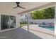 Relaxing covered patio overlooking a serene backyard with a sparkling pool and lush landscaping at 3220 W Frankfurt Dr, Chandler, AZ 85226