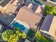 Aerial view of backyard featuring a uniquely shaped pool, green grass and privacy fence at 3220 W Frankfurt Dr, Chandler, AZ 85226