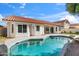 Beautiful backyard featuring a freeform pool, covered patio, and privacy for ultimate relaxation at 3220 W Frankfurt Dr, Chandler, AZ 85226