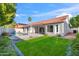 Inviting backyard with a sparkling pool, lush green lawn, and covered patio, perfect for outdoor living at 3220 W Frankfurt Dr, Chandler, AZ 85226