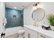 Stylish bathroom featuring blue tile accent wall, shower/tub, and updated vanity with gold fixtures at 3220 W Frankfurt Dr, Chandler, AZ 85226