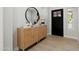 Stylish entryway featuring a decorative cabinet and elegant mirror at 3220 W Frankfurt Dr, Chandler, AZ 85226