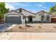 Inviting single-story home with a manicured yard, gray garage door and framed windows at 3220 W Frankfurt Dr, Chandler, AZ 85226