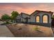 Charming single-story home featuring a well-kept front yard and a freshly sealed driveway under a serene sunset at 3220 W Frankfurt Dr, Chandler, AZ 85226