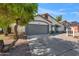Inviting single-story home with a gray garage door, meticulous landscaping, and an ample driveway at 3220 W Frankfurt Dr, Chandler, AZ 85226