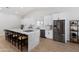 Updated kitchen featuring stainless steel appliances, white cabinetry, and spacious quartz counter tops at 3220 W Frankfurt Dr, Chandler, AZ 85226