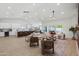 Bright living room with vaulted ceiling, ceiling fan, modern furniture and view of the kitchen at 3220 W Frankfurt Dr, Chandler, AZ 85226