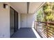 A private balcony features a metal railing, door, and sliding glass door, offering a tranquil outdoor space at 3330 W Danbury Dr # E203, Phoenix, AZ 85053