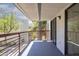 This balcony offers a spacious outdoor area perfect for relaxing, with a modern metal railing and sliding glass doors at 3330 W Danbury Dr # E203, Phoenix, AZ 85053