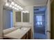 Bathroom vanity features wood cabinets, white countertop, and bright lighting at 3330 W Danbury Dr # E203, Phoenix, AZ 85053