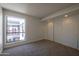 Bedroom features plush carpet, window, and closet with sliding doors at 3330 W Danbury Dr # E203, Phoenix, AZ 85053