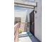 A welcoming entryway featuring a secure gate, cheerful welcome mat, and unit number E203 at 3330 W Danbury Dr # E203, Phoenix, AZ 85053