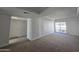 Bright, spacious living room featuring new carpeting and sliding glass doors to a balcony, enhancing the living space at 3330 W Danbury Dr # E203, Phoenix, AZ 85053