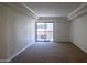 Bright living room with plush carpet and sliding glass door at 3330 W Danbury Dr # E203, Phoenix, AZ 85053