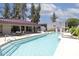 A sparkling community pool with lounge chairs and tables surrounded by lush landscaping at 3330 W Danbury Dr # E203, Phoenix, AZ 85053