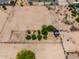 Aerial photograph of an enclosed desert lot, partially landscaped with mature trees and shrubbery at 3614 W Phillips Rd, San Tan Valley, AZ 85144