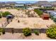 Expansive dirt backyard with large sheds and storage areas, secured with fences and block wall at 3614 W Phillips Rd, San Tan Valley, AZ 85144