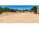 Spacious backyard features desert landscaping, gated areas, mountain views, and a charming red outbuilding at 3614 W Phillips Rd, San Tan Valley, AZ 85144