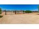 Spacious backyard features desert landscaping, multiple gated areas, and views of nearby homes, mountains, and blue skies at 3614 W Phillips Rd, San Tan Valley, AZ 85144