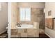 Bathroom featuring tiled walls, travertine flooring, drop in tub, and shower with frameless glass enclosure at 3614 W Phillips Rd, San Tan Valley, AZ 85144