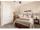 Bedroom featuring shuttered windows, neutral colored walls, ceiling fan, and a full sized bed with a patterned bedspread at 3614 W Phillips Rd, San Tan Valley, AZ 85144