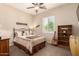 Bedroom featuring shuttered windows, neutral colored walls, ceiling fan, and a full sized bed with a patterned bedspread at 3614 W Phillips Rd, San Tan Valley, AZ 85144