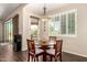 Cozy dining area with wooden table and chairs, a modern light fixture, and access to the backyard at 3614 W Phillips Rd, San Tan Valley, AZ 85144