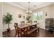 Bright dining area with stylish lighting, table, and view to the front yard at 3614 W Phillips Rd, San Tan Valley, AZ 85144