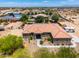 Sprawling single-story home with desert landscaping, private drive, and neighboring structures in the distance at 3614 W Phillips Rd, San Tan Valley, AZ 85144